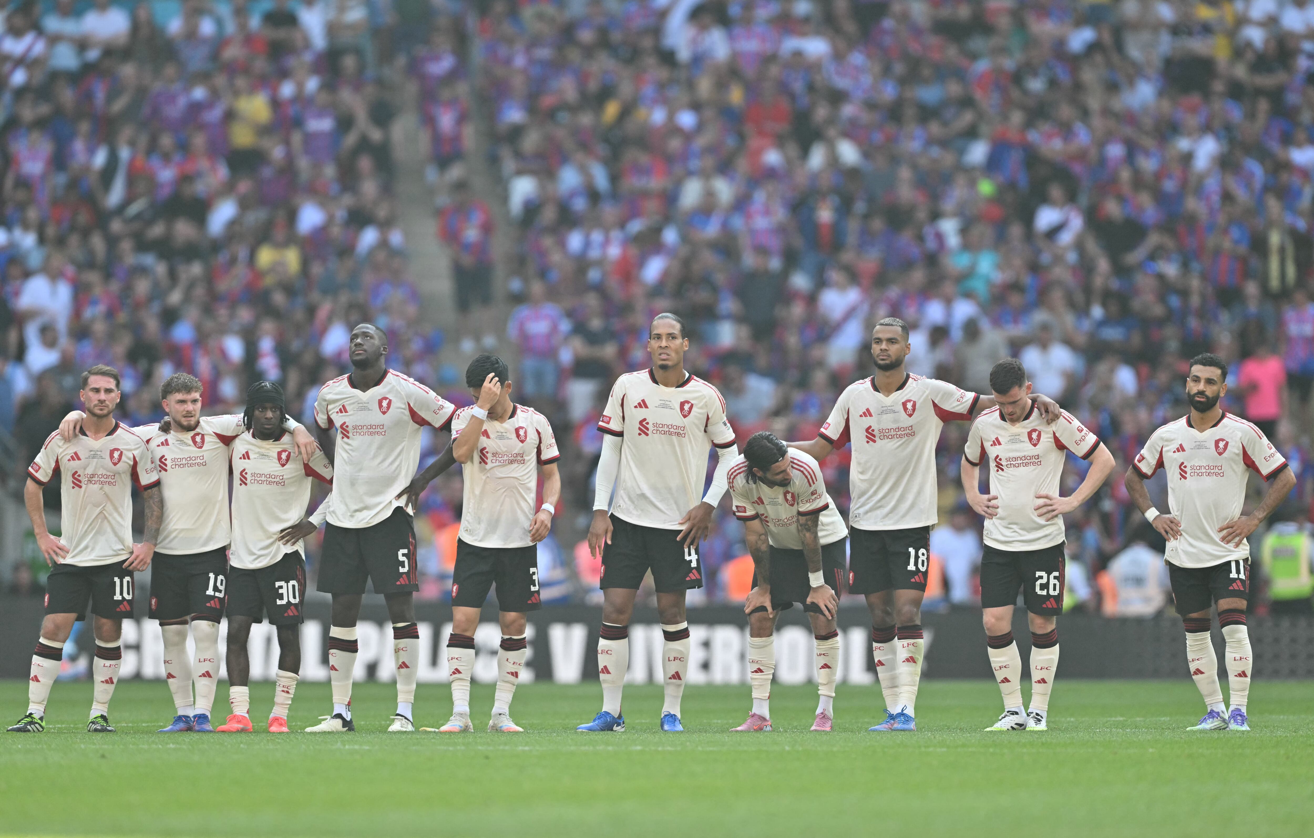 Liverpool players look forward to the penalty shoot out during the English FA Community Shield football match between Crystal Palace and Liverpool at Wembley Stadium, in London on August 10, 2025. (Photo by Glyn KIRK / AFP) / NOT FOR MARKETING OR ADVERTISING USE / RESTRICTED TO EDITORIAL USE