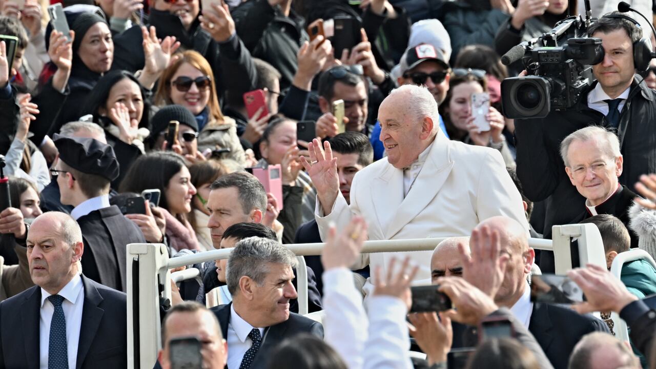 Pope Francis greets the crowd as he arrives for his general audience in St. Peter Square at the Vatican on March 13, 2024. (Photo by Andreas SOLARO / AFP)
