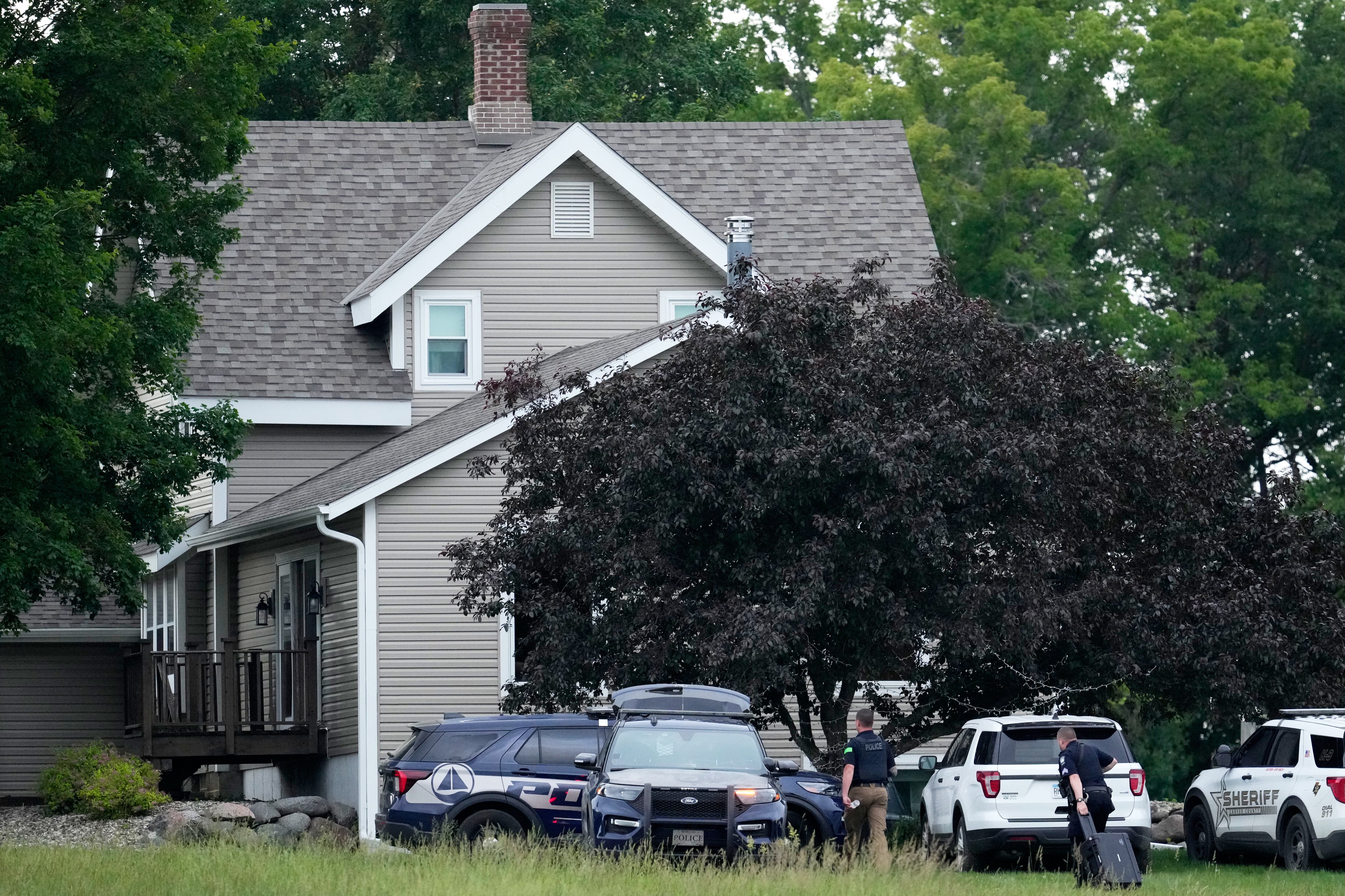 Law enforcement officers investigate the home of shooting suspect Vance Boelter, Sunday, June 15, 2025, in Green Isle, Minn. (AP Photo/George Walker IV)