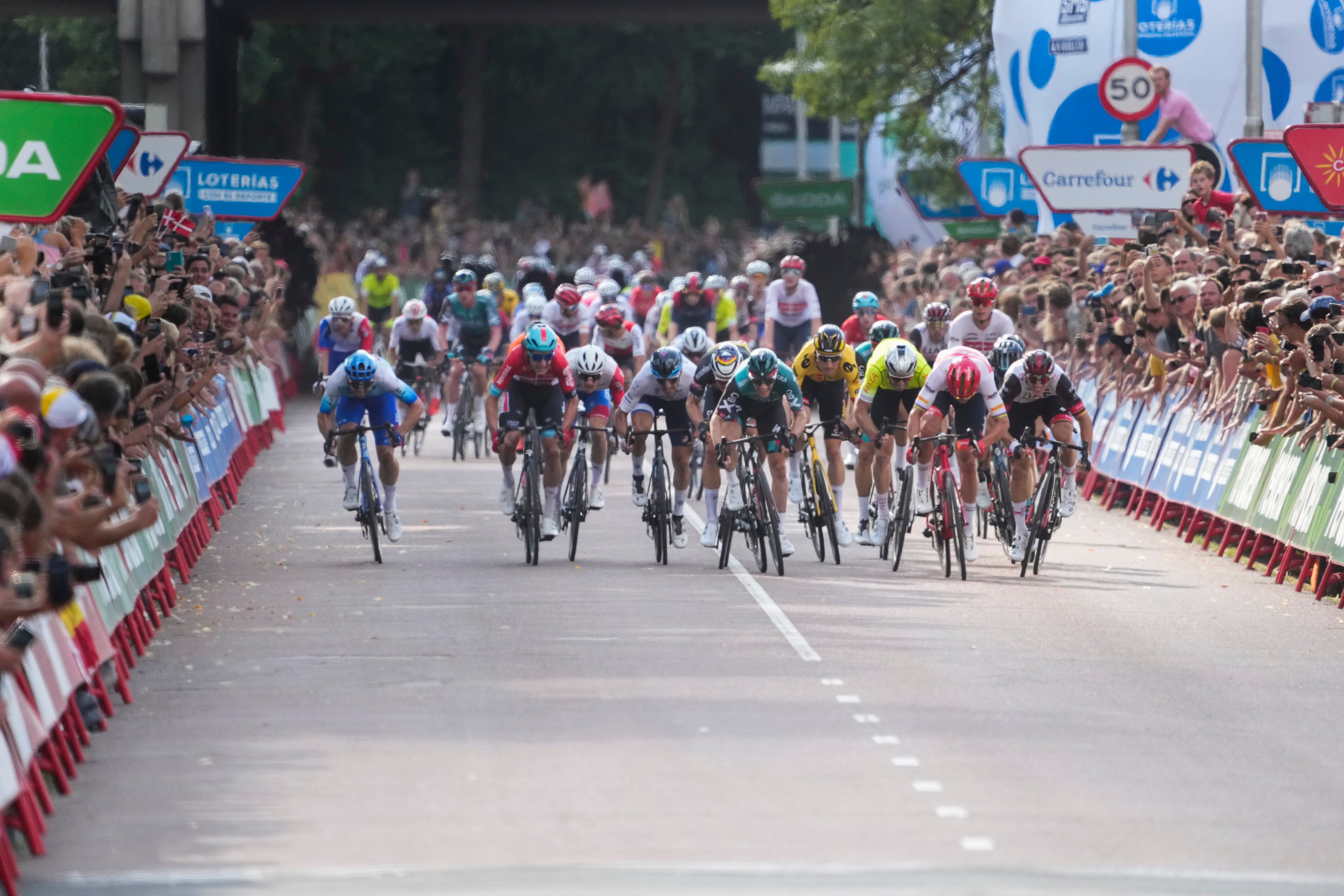 Ireland's Sam Bennett, center in green, sprints towards the finish line to win the second stage of the Vuelta cycling race over 175.1 kilometers (108.8 miles) with start in Den Bosch and finish in Utrecht, Netherlands, Saturday, Aug. 20, 2022. (AP Photo/Peter Dejong)