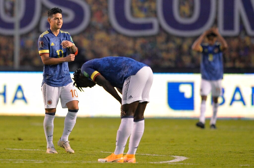 Colombia's James Rodriguez, left, leaves the field at the end of a qualifying soccer match against Ecuador for the FIFA World Cup Qatar 2022 in Quito, Ecuador, Tuesday, Nov. 17, 2020. Ecuador won 6-1. (Rodrigo Buendia, Pool via AP)