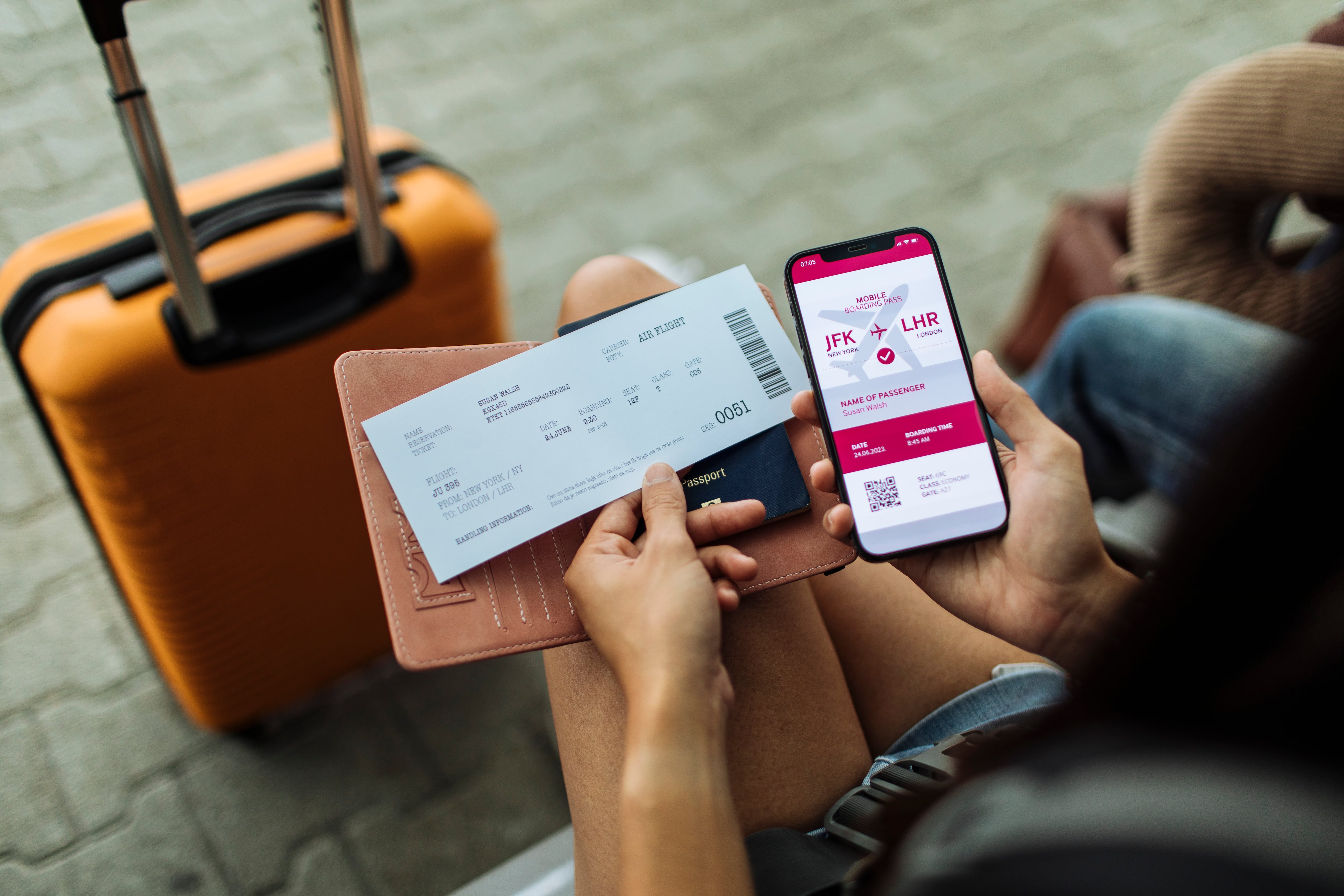Close-up of the passport, phone, and ticket, with a bag in the distance