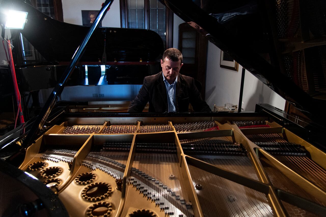 Italian piano craftsman Luigi Borgato plays on a Borgato Grand Prix 333 piano in his workshop in Borgo Veneto, near Padua on April 8, 2021. - Italian craftsman Luigi Borgato grew his business into a prestigious brand capable of attracting buyers from all over the world, until the coronavirus pandemic abruptly put a halt to it all. (Photo by MARCO BERTORELLO / AFP)