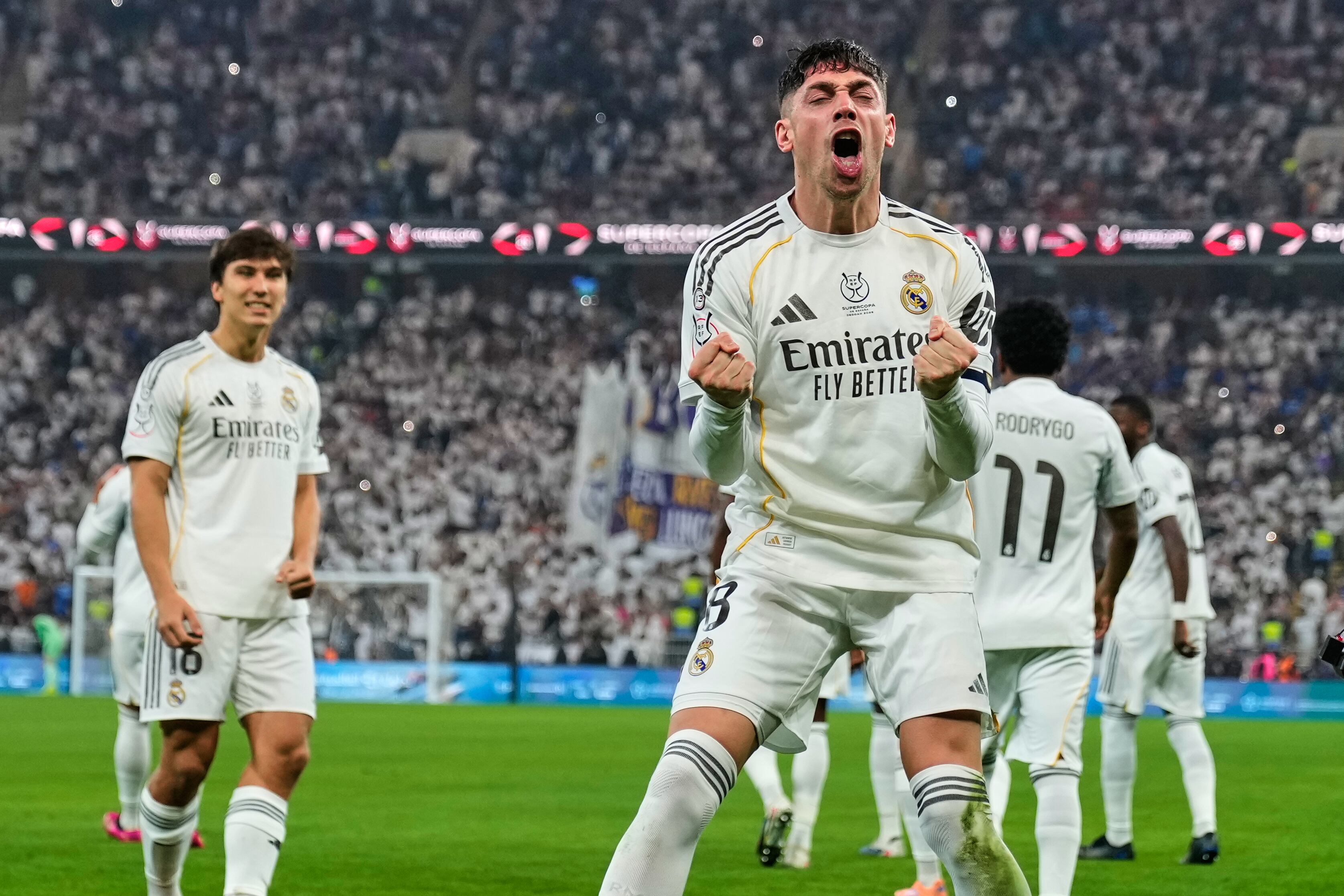 Real Madrid's Federico Valverde, foreground, celebrates after scoring the opening goal during the Spanish Super Cup semifinal soccer match against Atletico Madrid at King Abdullah Sports City Stadium in Jeddah, Saudi Arabia, Thursday, Jan. 8, 2026. (AP Photo/Altaf Qadri)
