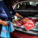 Anti-abortion activist Madelyn Ocasio takes banners and posters from her car outside of her house in Miami, Florida, on May 3, 2022. - The Supreme Court is poised to strike down the right to abortion in the US, according to a leaked draft of a majority opinion that would shred nearly 50 years of constitutional protections. The draft, obtained by Politico, was written by Justice Samuel Alito, and has been circulated inside the conservative-dominated court, the news outlet reported. Politico stressed that the document it obtained is a draft and opinions could change. The court is expected to issue a decision by June. The draft opinion calls the landmark 1973 Roe v Wade decision "egregiously wrong from the start." (Photo by CHANDAN KHANNA / AFP)