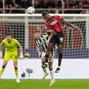 AC Milan's Rafael Leao, right, goes for the header with Newcastle's Kieran Trippier during the Champions League group F soccer match between AC Milan and Newcastle at the San Siro stadium in Milan, Italy, Tuesday, Sept. 19, 2023. (AP Photo/Antonio Calanni)