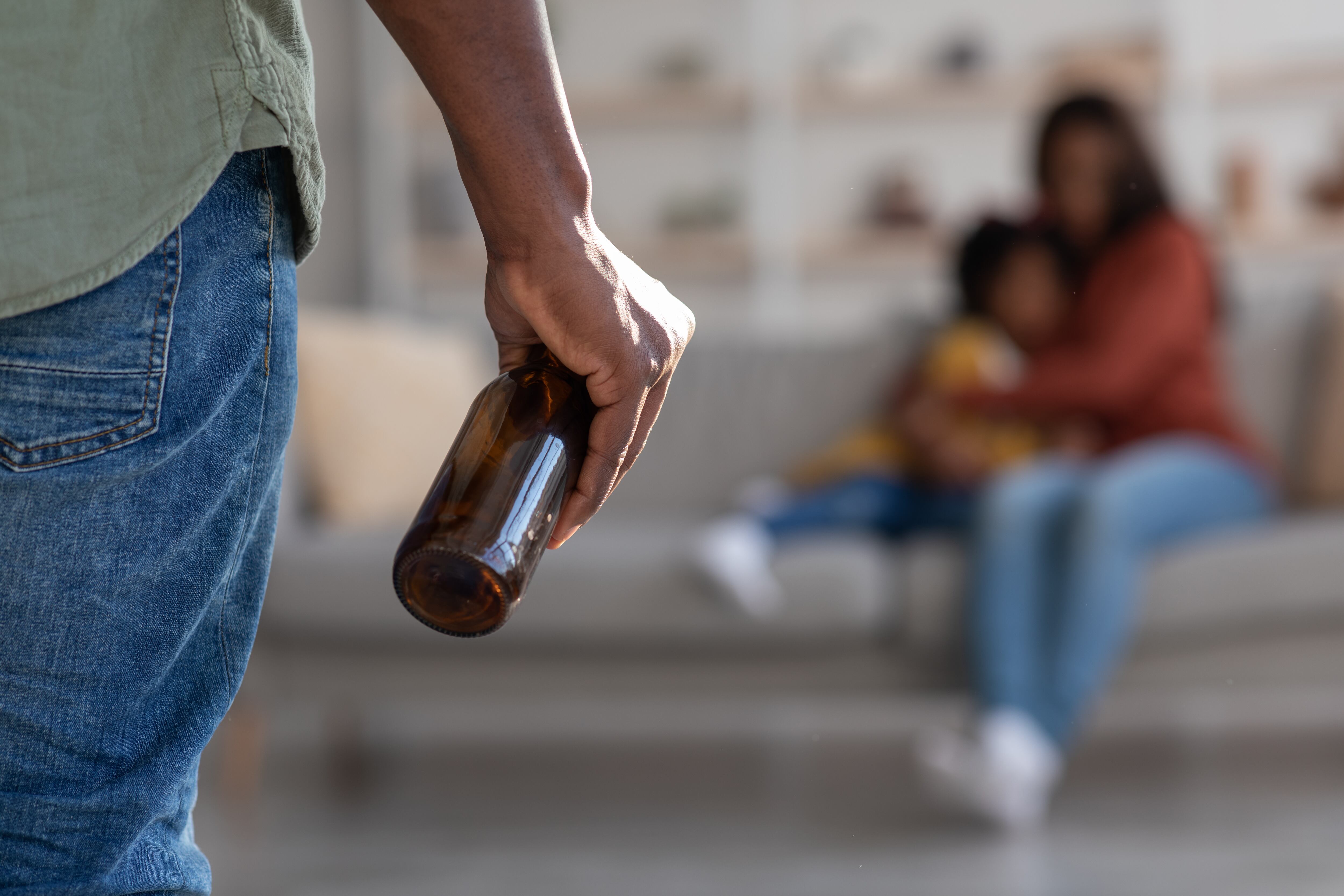 Black Man Holding Bottle Of Alcohol separación