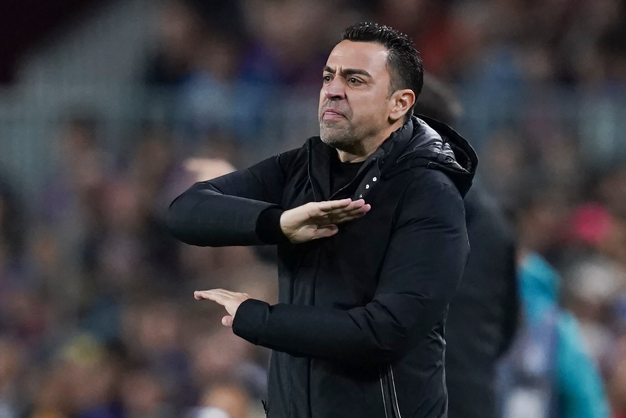 Barcelona's head coach Xavi Hernandez reacts during the Spanish La Liga soccer match between Barcelona and Real Madrid at Camp Nou stadium in Barcelona, Spain, Sunday, March 19, 2023. (AP Photo/Joan Mateu)