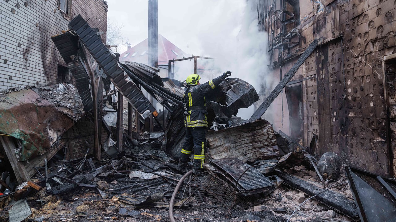 Los rescatistas retiran los escombros del tejado de un edificio de apartamentos dañado tras un ataque ruso en Kiev, Ucrania.