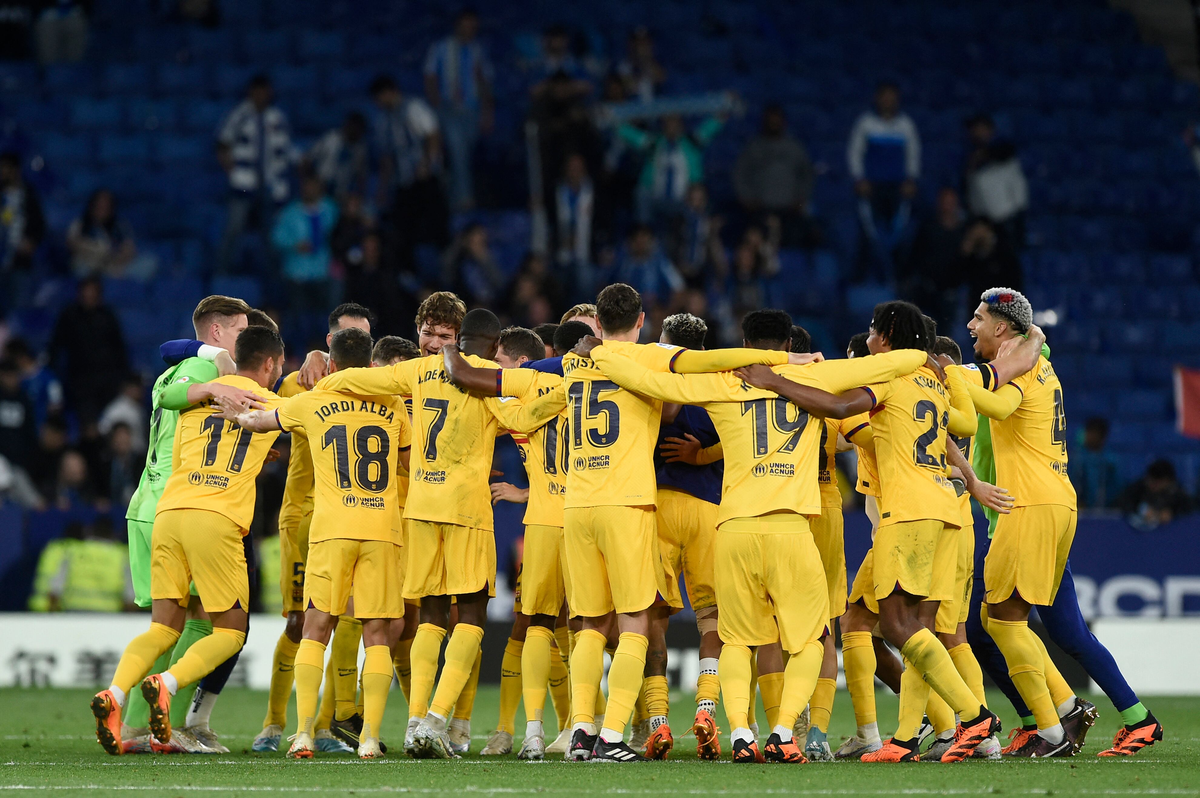 Barcelona's players celebrate winning their 27th Spanish league championship after the Spanish league football match between RCD Espanyol and FC Barcelona at�the RCDE Stadium in Cornella de Llobregat on May 14, 2023. Barcelona won Spain's La Liga for the first time since 2019 by thrashing Espanyol 4-2 today, wrestling the title from rivals Real Madrid. The Catalan giants clinched their 27th Spanish championship with an emphatic derby victory, with Robert Lewandowski scoring twice, alongside Alejandro Balde and Jules Kounde's goals. (Photo by Josep LAGO / AFP)