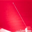 In this handout infrared photo from the U.S. Navy, the USS Portland fires a laser weapon system at a target floating in the Gulf of Aden on Tuesday, Dec. 14, 2021. The U.S. Navy announced Wednesday it tested a laser weapon and destroyed a floating target in the Mideast, a system that could be used to counter bomb-laden drone boats deployed by Yemen's Houthi rebels in the Red Sea. (Mass Communication Specialist 2nd Class Devin Kates/U.S. Marine Corps via AP)