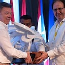 Juan Manuel Santos y Leonidas Bustos