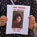 A protester holds the famous Afghan Girl photo - a 1984 photographic portrait of Sharbat Gula by photojournalist Steve McCurry with the words 'You Valued My Beauty, Now You Value My Life.'
Members of the local Afghan diaspora, activists and local supporters seen in front of the Alberta Legislature Building during the STOP KILLING AFGHANS! protest organised today by the Global Movement of Peace for Afghanistan.
Saturday, August 28, 2021, in Edmonton, Alberta, Canada. (Photo by Artur Widak/NurPhoto via Getty Images)