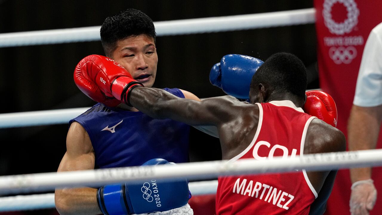 Colombia's Yuberjen Herney Martinez Rivas, right, exchanges punches with Japan's Ryomei Tanaka in their men's flyweight 52-kg quarterfinal boxing match at the 2020 Summer Olympics, Tuesday, Aug. 3, 2021, in Tokyo, Japan. (AP Photo/Themba Hadebe)