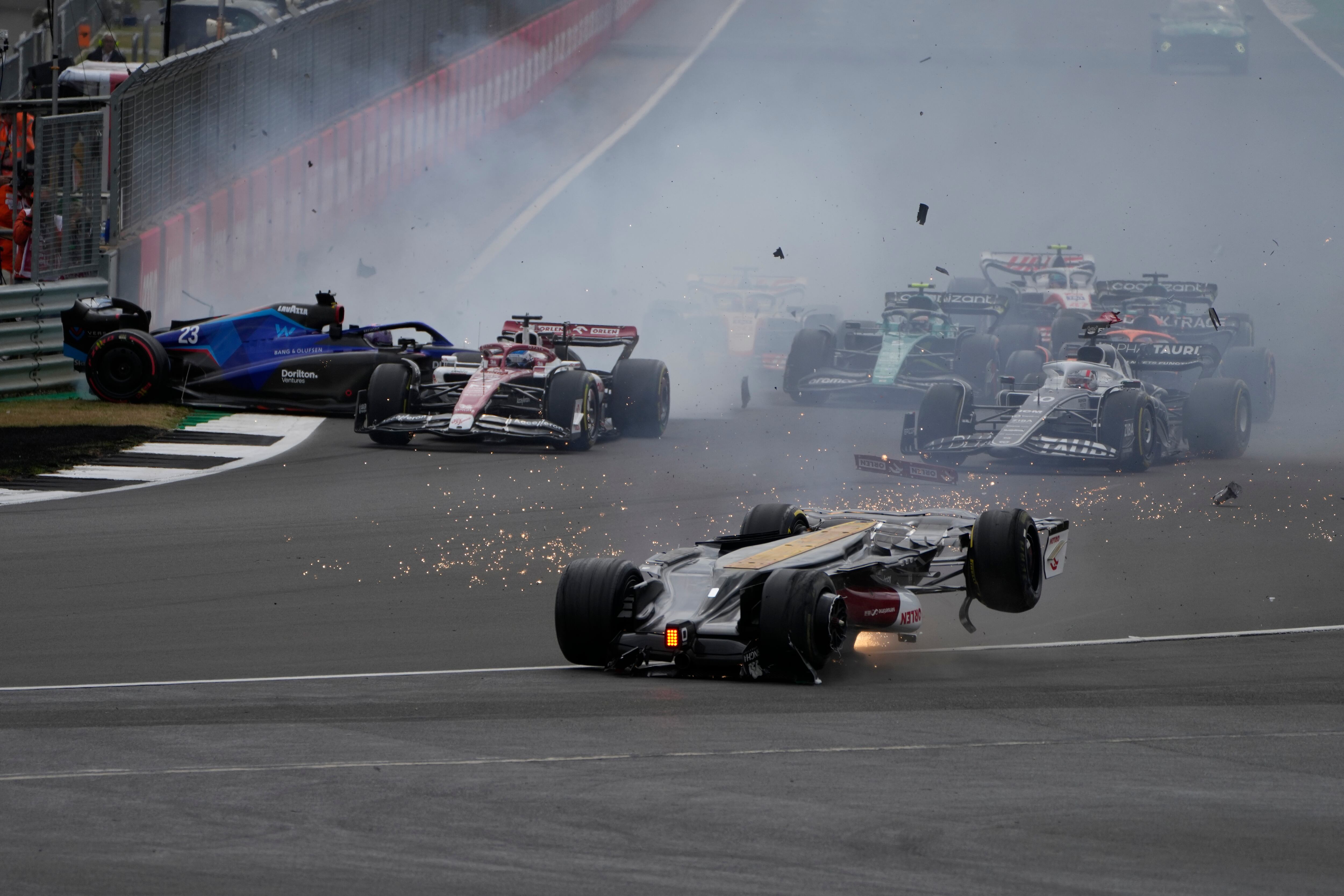 Alfa Romeo driver Guanyu Zhou of China crashes at the start of the British Formula One Grand Prix at the Silverstone circuit, in Silverstone, England, Sunday, July 3, 2022. (AP Photo/Frank Augstein)