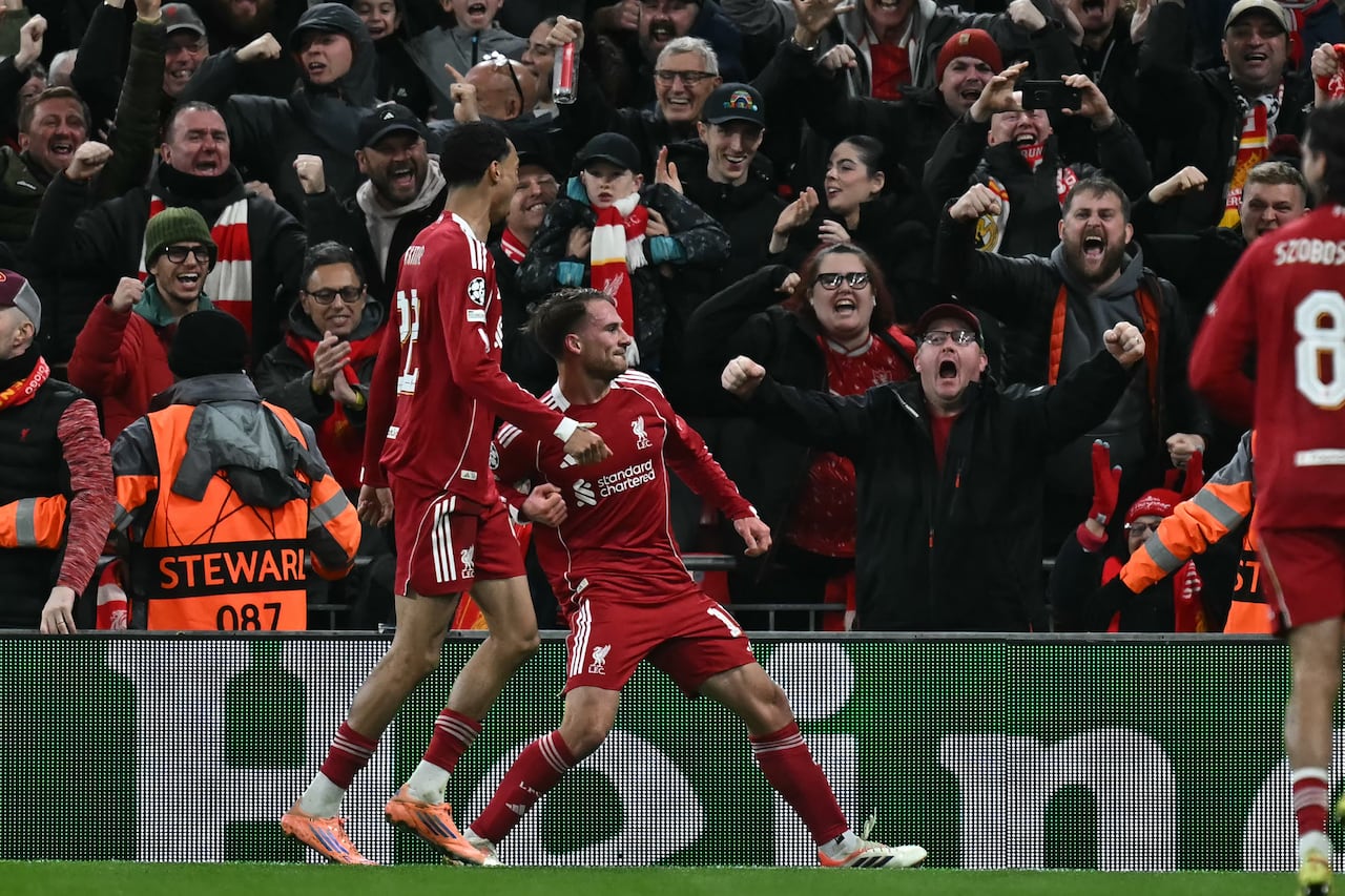 Liverpool's Argentinian midfielder #10 Alexis Mac Allister (C) celebrates after scoring the opening goal of the UEFA Champions League, league phase football match between Liverpool and Real Madrid at Anfield in Liverpool, north west England on November 4, 2025. (Photo by Paul ELLIS / AFP)