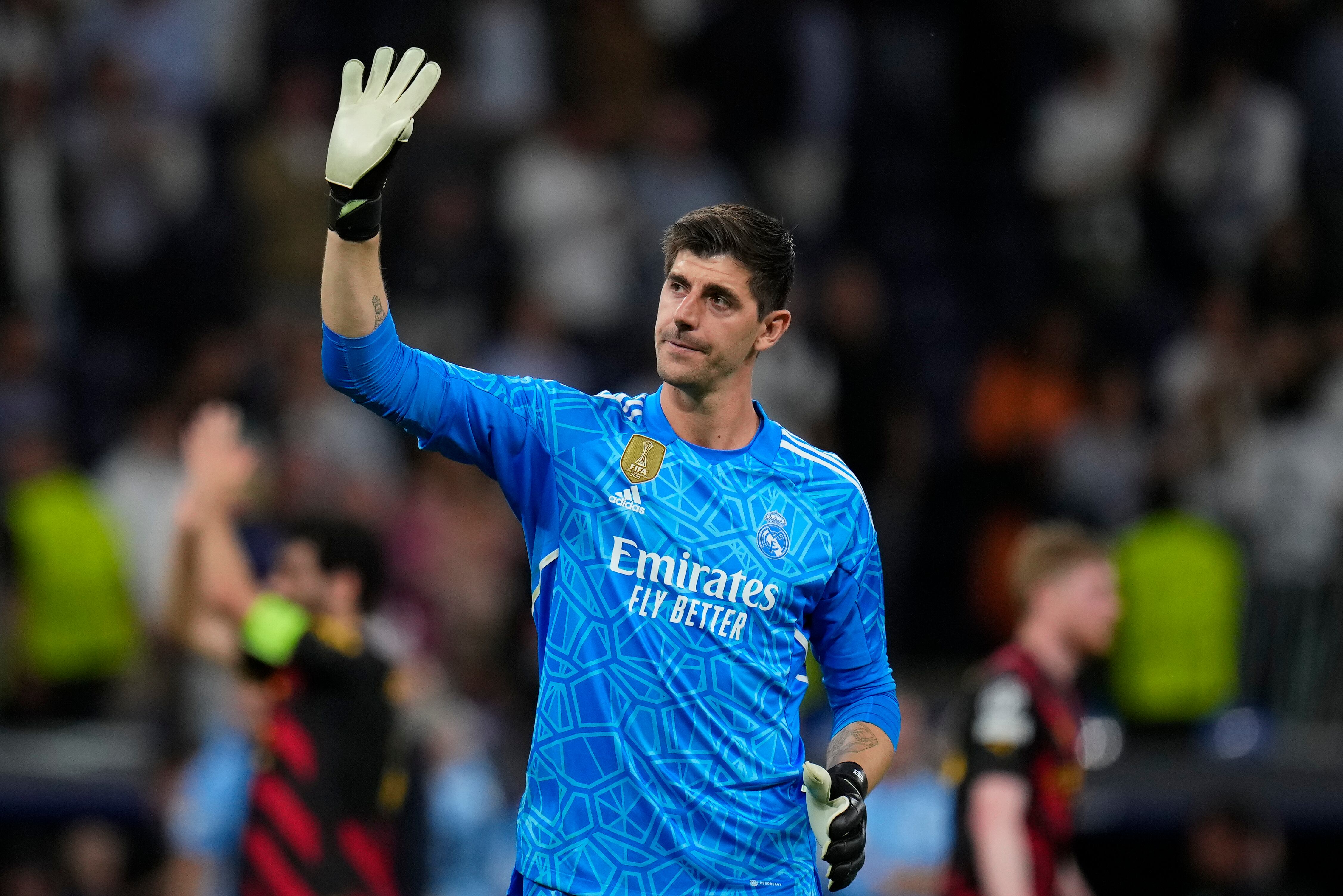 FILE - Real Madrid's goalkeeper Thibaut Courtois waves to fans at the end of the Champions League semifinal first leg soccer match between Real Madrid and Manchester City at the Santiago Bernabeu stadium in Madrid, Spain, Tuesday, May 9, 2023. Real Madrid says goalkeeper Thibaut Courtois has torn a ligament in his left knee and will require surgery. Local media reports that the injury occurred during training. (AP Photo/Manu Fernandez, File)