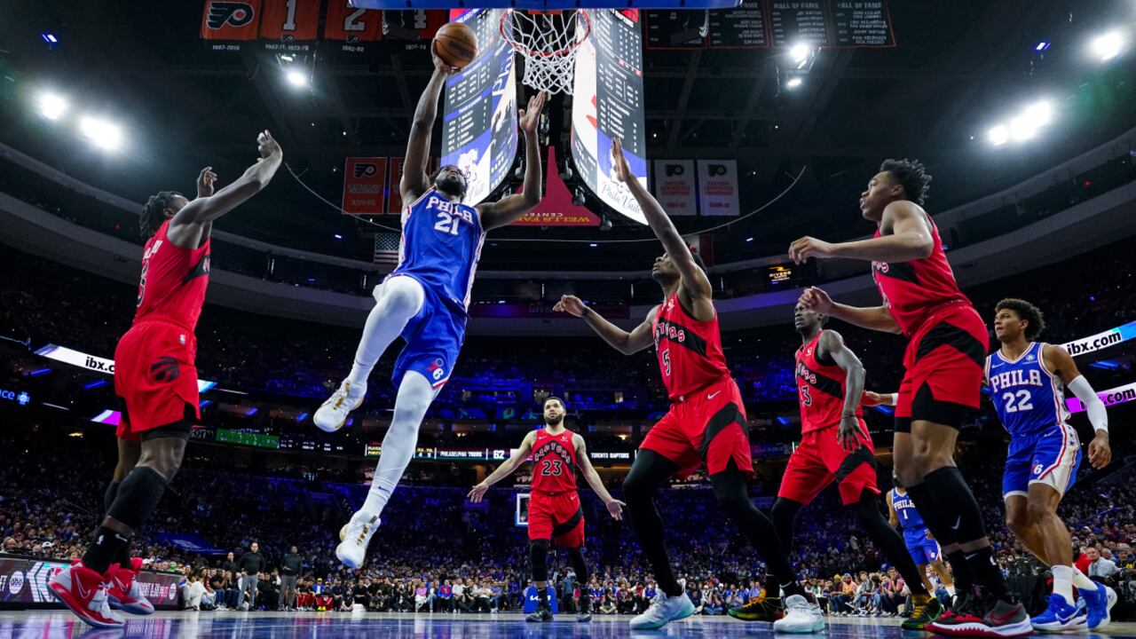 Philadelphia 76ers' Joel Embiid, center left, goes up for the shot against the Toronto Raptors during the first half of Game 1 of an NBA basketball first-round playoff series, Saturday, April 16, 2022, in Philadelphia. (AP/Chris Szagola)