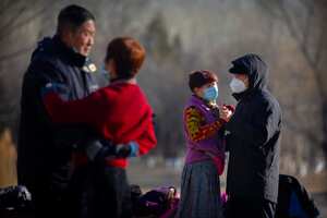 People wearing face masks to help curb the spread of the coronavirus dance at a public park in Beijing, Tuesday, Jan. 5, 2021. China has designated parts of Hebei province near Beijing as a coronavirus high danger zone after 14 new cases of COVID-19 were found. (AP Photo/Mark Schiefelbein)