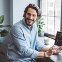 Businessman working from home. Using laptops. Trading stock or cryptocurrencies. Trading app on screen.