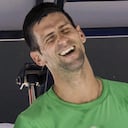 Defending men's champion Serbia's Novak Djokovic laughs as he rests during a practice session on Margaret Court Arena ahead of the Australian Open tennis championship in Melbourne, Australia, Thursday, Jan. 13, 2022. AP Photo/Mark Baker)