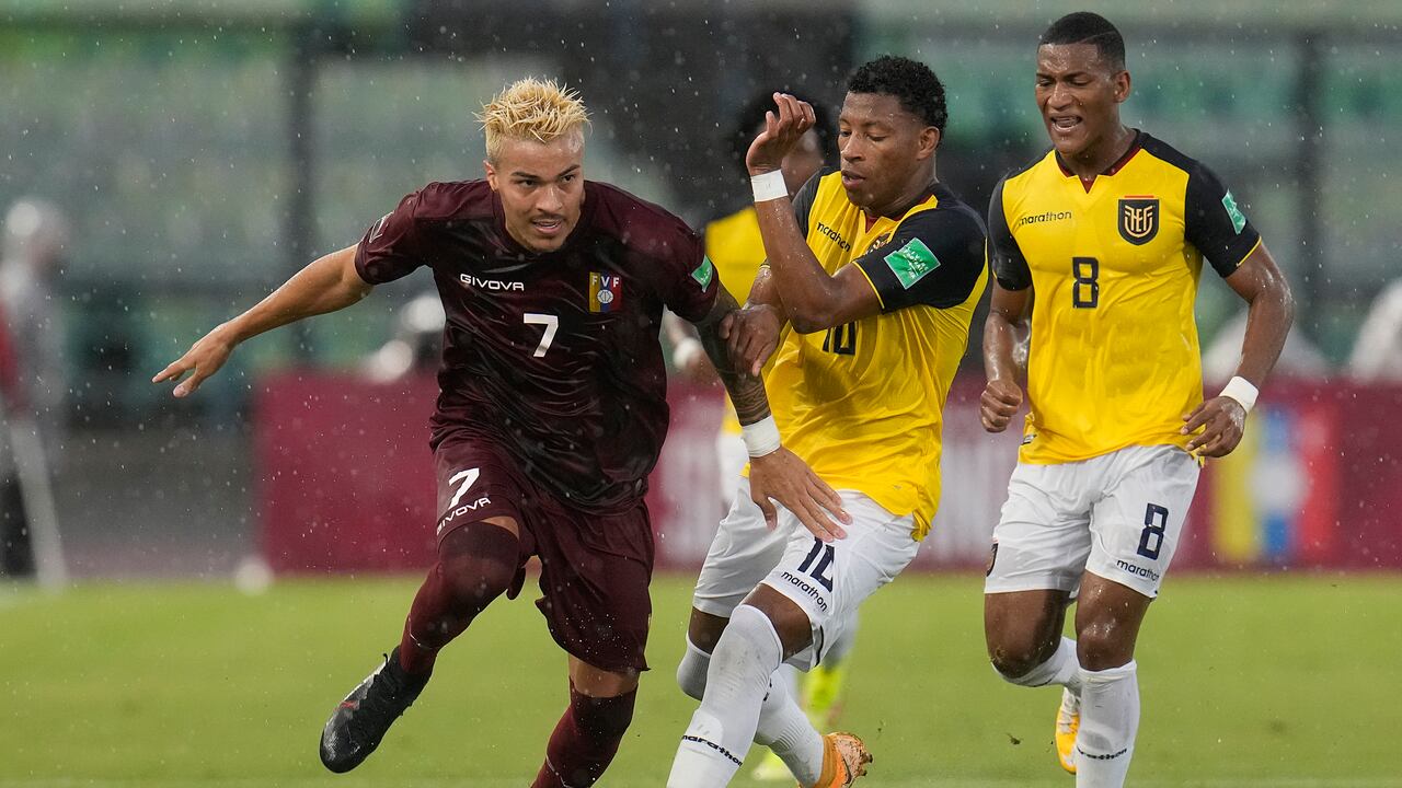 Venezuela's Adalberto Penaranda, left, and Ecuador's Gonzalo Plata fight for the ball during a qualifying soccer match for the FIFA World Cup Qatar 2022 at UCV Olympic Stadium in Caracas, Venezuela, Sunday, Oct. 10, 2021. (AP Photo/Ariana Cubillos)