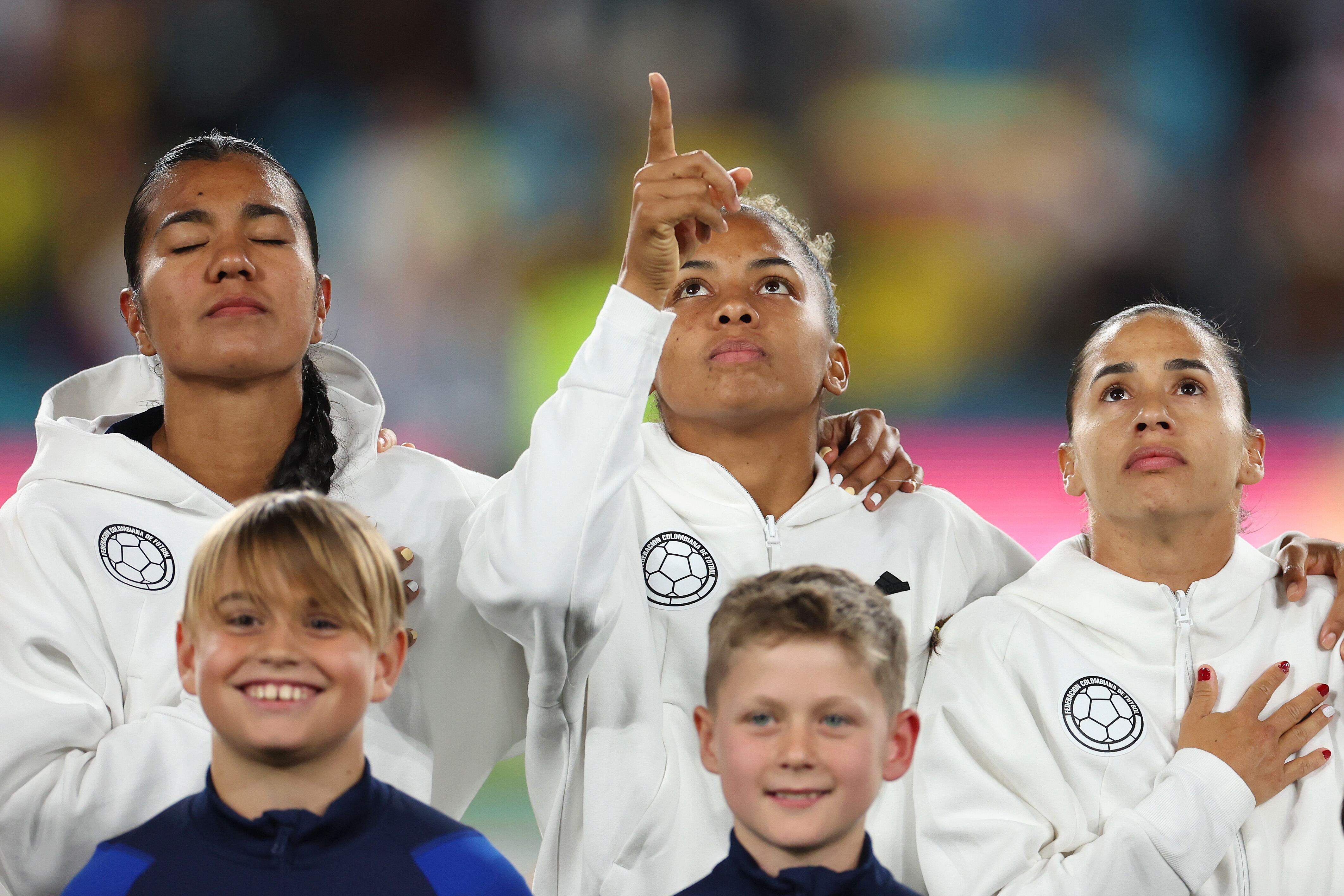 SYDNEY, AUSTRALIA - AUGUST 12: (L-R) Daniela Arias, Jorelyn Carabali and Carolina Arias of Colombia line up for the national anthems prior to the FIFA Women's World Cup Australia & New Zealand 2023 Quarter Final match between England and Colombia at Stadium Australia on August 12, 2023 in Sydney, Australia. (Photo by Catherine Ivill/Getty Images )