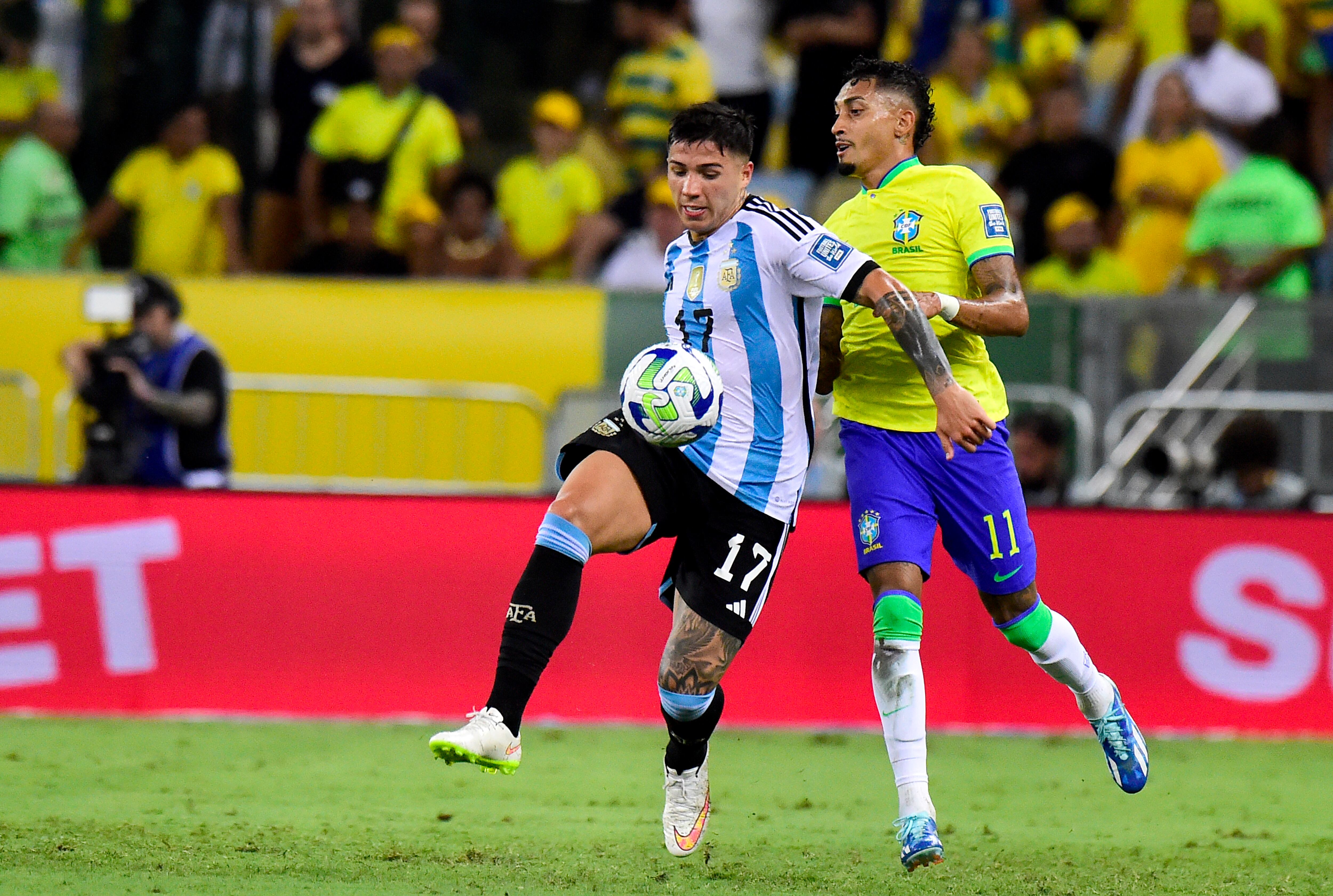 RIO DE JANEIRO, BRAZIL - NOVEMBER 21: Enzo Fernandez of Argentina competes for the ball with Raphinha of Brazil during a FIFA World Cup 2026 Qualifier match between Brazil and Argentina at Maracana Stadium on November 21, 2023 in Rio de Janeiro, Brazil. (Photo by MB Media/Getty Images)