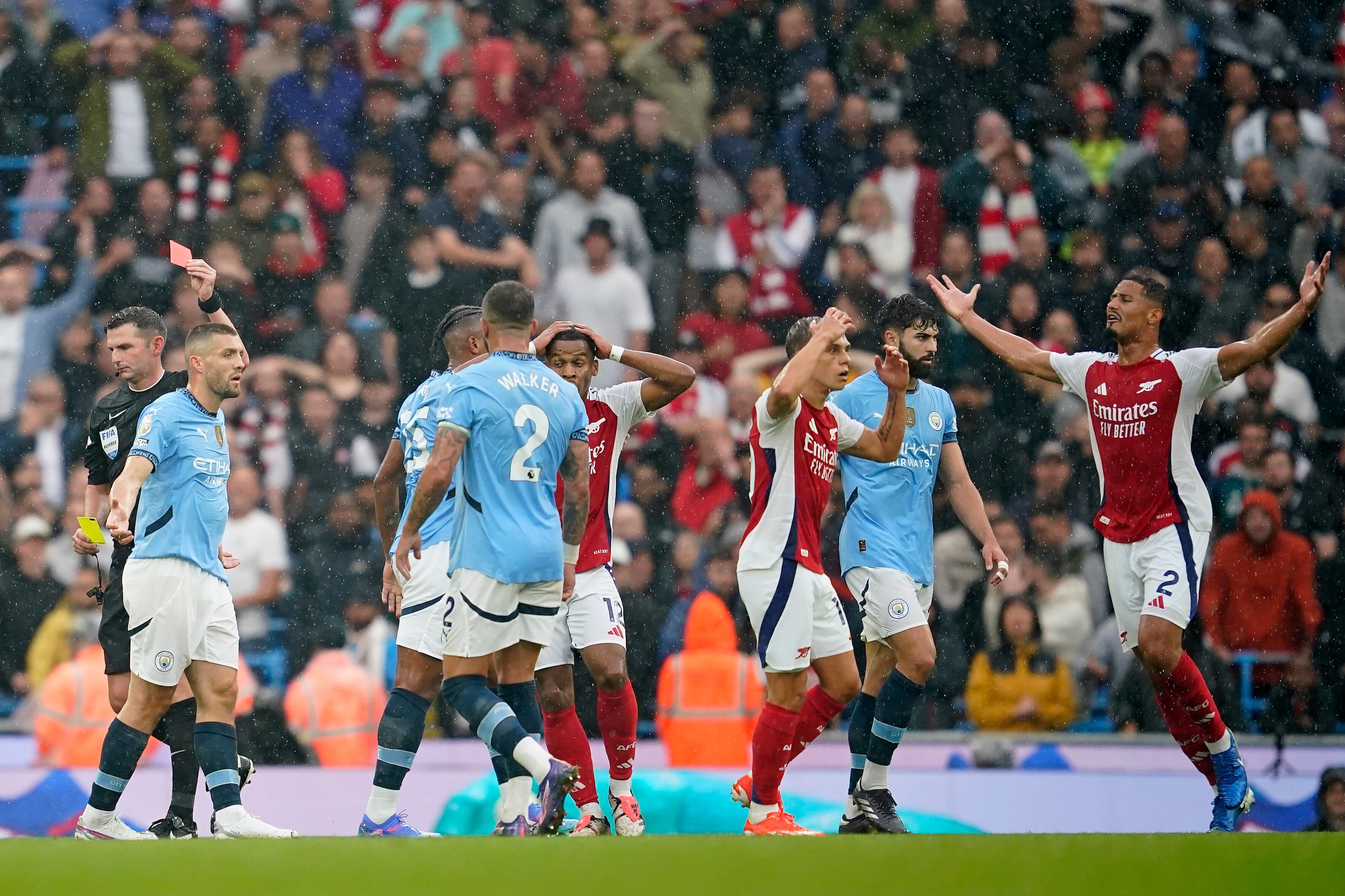 Arsenal's Leandro Trossard, third right, reacts after getting a red card during the English Premier League soccer match between Manchester City and Arsenal at the Etihad stadium in Manchester, England, Sunday, Sept. 22, 2024. (AP Photo/Dave Thompson)