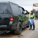 La enfermera María Varela entrega almuerzos para llevar a las personas que hacen fila para cargar combustible en Fort Providence, Territorios del Noroeste, el jueves 17 de agosto de 2023. (Jeff McIntosh/The Canadian Press vía AP)