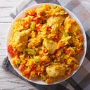 Hispanic cuisine: Arroz con pollo close up in a bowl on the table. horizontal top view