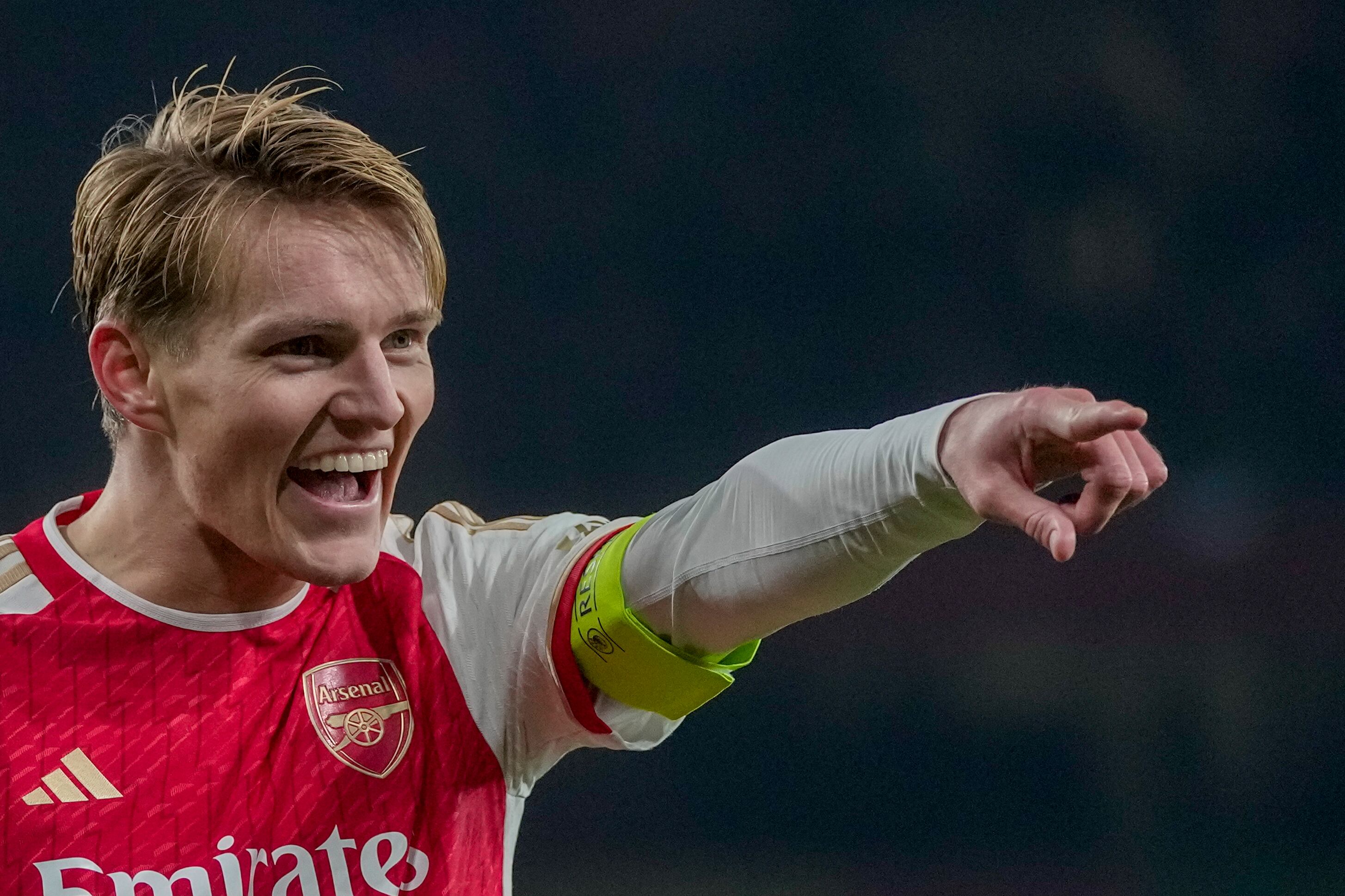 Arsenal's Martin Odegaard celebrates after scoring his side's fifth goal during the Champions League Group B soccer match between Arsenal and Lens, at Emirates stadium, in London, Wednesday, Nov. 29, 2023. (AP Photo/Kin Cheung)