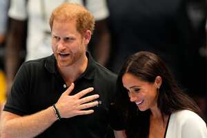 Britain's Prince Harry and Meghan, The Duke and Duchess of Sussex, walk on a court at the Invictus Games in Duesseldorf, Germany, Wednesday, Sept. 13, 2023. Harry founded the Invictus Games to aid the rehabilitation of service members and veterans by giving them the challenge of competing in sports events similar to the Paralympics. (AP Photo/Martin Meissner)