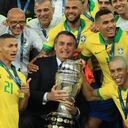 RIO DE JANEIRO, BRAZIL - JULY 07: President of Brazil Jair Bolsonaro celebrates with the trophy and the players of Brazil after winning the Copa America Brazil 2019 Final match between Brazil and Peru at Maracana Stadium on July 07, 2019 in Rio de Janeiro, Brazil. (Photo by Buda Mendes/Getty Images)
