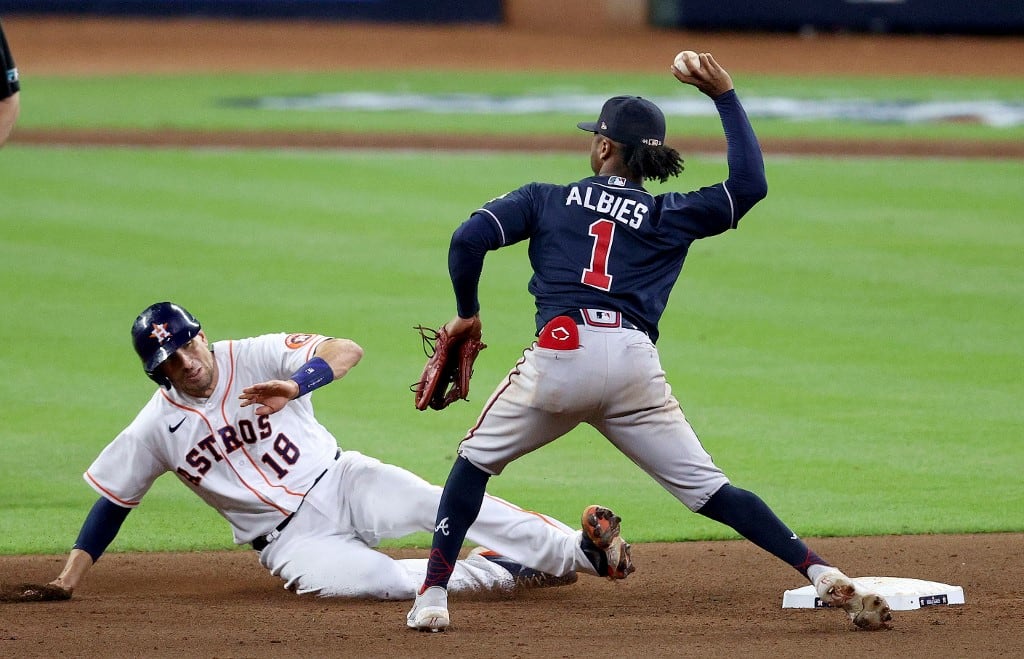 Ozzie Albies # 1 de los Bravos de Atlanta intenta convertir el doble play después de hacer el out a Jason Castro # 18 de los Astros de Houston durante la novena entrada en el Juego Uno de la Serie Mundial en Minute Maid Park el 26 de octubre de 2021 en Houston. Texas. Patrick Smith / Getty Images / AFP