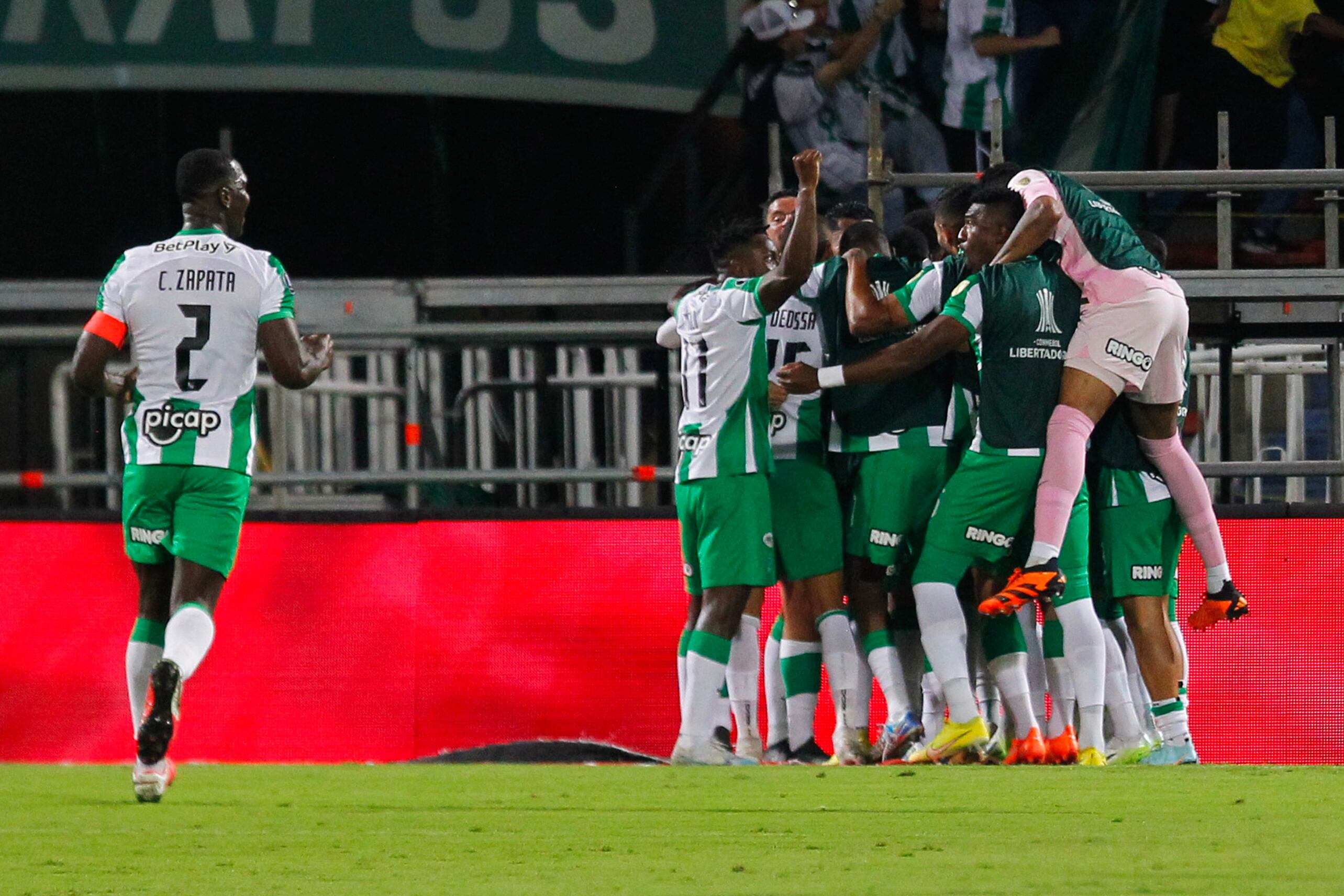 Players of Atletico Nacional celebrate after scoring during the Copa Libertadores round of 16 first leg football match between Colombia's Atletico Nacional and Argentina's Racing Club at the Atanasio Girardot stadium in Medellin, Colombia, on August 3, 2023. (Photo by Fredy BUILES / AFP)