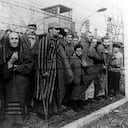 Survivors of Auschwitz behind a barbed wire fence, Poland, February 1945. Photo taken by a Russian photographer during the making of a film about the liberation of the camp. The children were dressed up by the Russians with clothing from adult prisoners. (Photo by Galerie Bilderwelt/Getty Images)