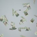 Hand grasping at fluttering money