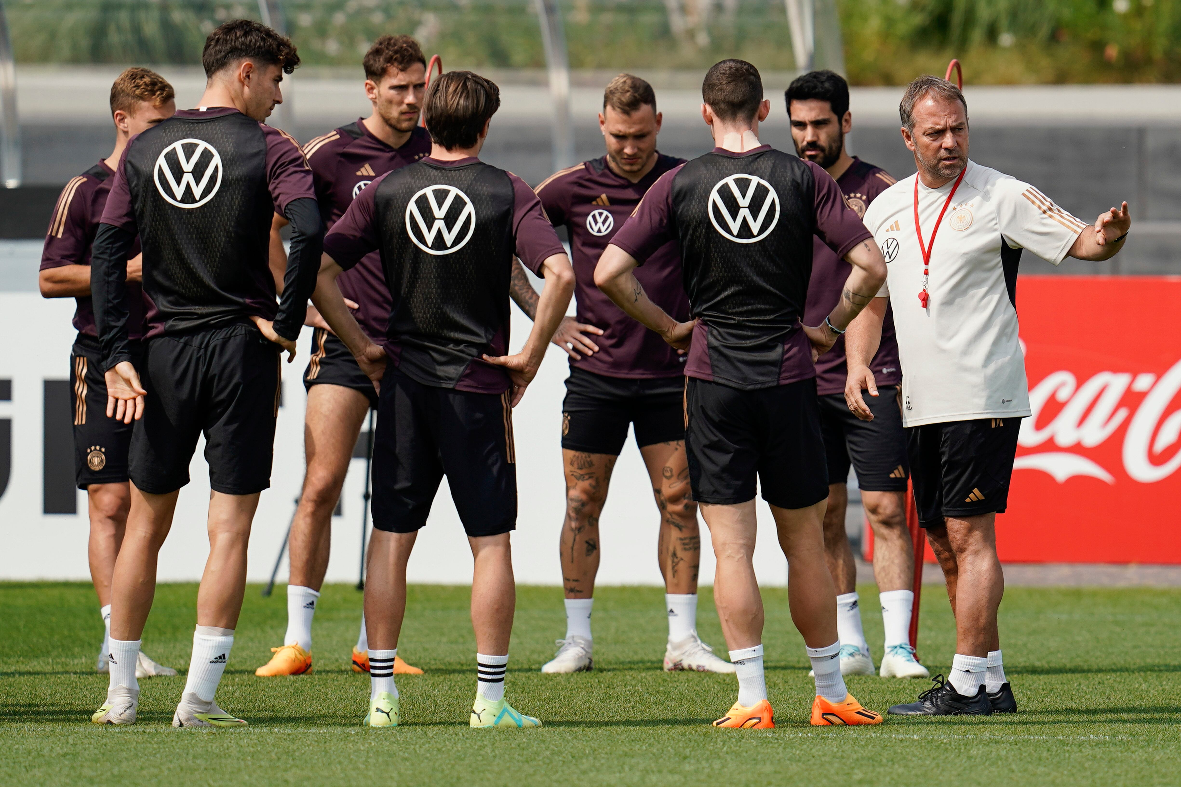 Germany coach Hansi Flick, right, talks to players during a team training session, in Frankfurt, Germany, Monday, June 19, 2023. Germany plays Colombia in an international friendly soccer match on Tuesday in Gelsenkirchen.  (Uwe Anspach/dpa via AP)