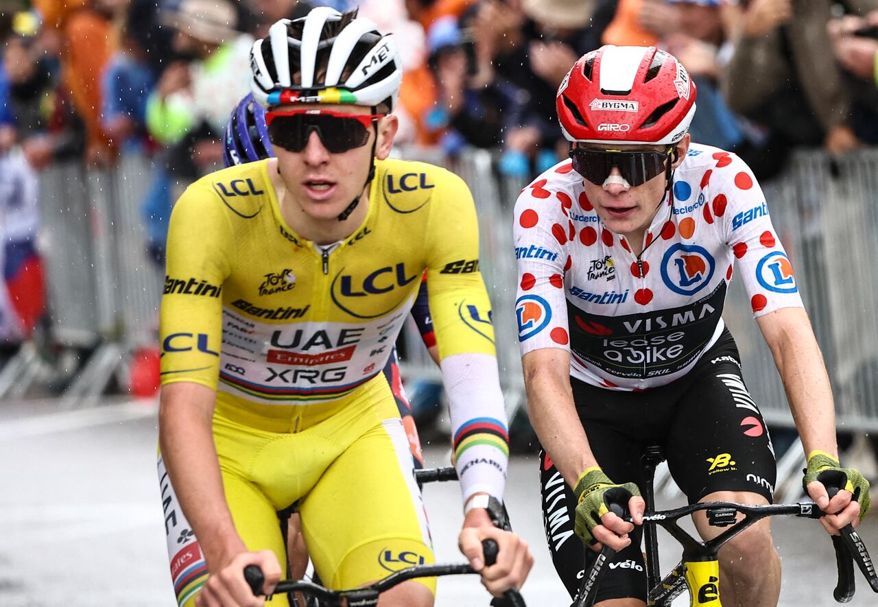 UAE Team Emirates - XRG team's Slovenian rider Tadej Pogacar wearing the overall leader's yellow jersey and Team Visma - Lease a bike team's Danish rider Jonas Vingegaard wearing the best climber's polka dot (dotted) jersey cycle in the final ascent of La Plagne during the 19th stage of the 112th edition of the Tour de France cycling race, 93.1 km between Albertville and La Plagne, in the French Alps, on July 25, 2025. The 19th stage of the Tour de France was shorted from its initial 129.9 km route, bypassing the Col des Saisies where an outbreak of nodular dermatitis in a herd of cattle was discovered, prompting organizers to modify the race route. (Photo by Anne-Christine POUJOULAT / AFP)