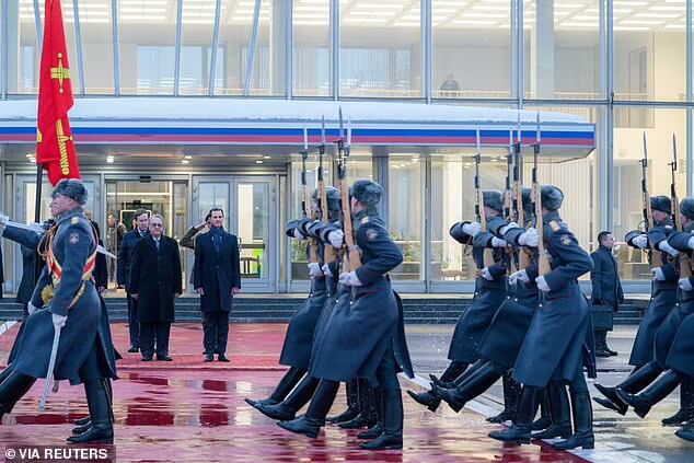 Syrian President Bashar al-Assad reviews Russian honour guards today as he stands with Russian Deputy Foreign Minister Mikhail Bogdanov upon his arrival at Vnukovo International Airport in Moscow
