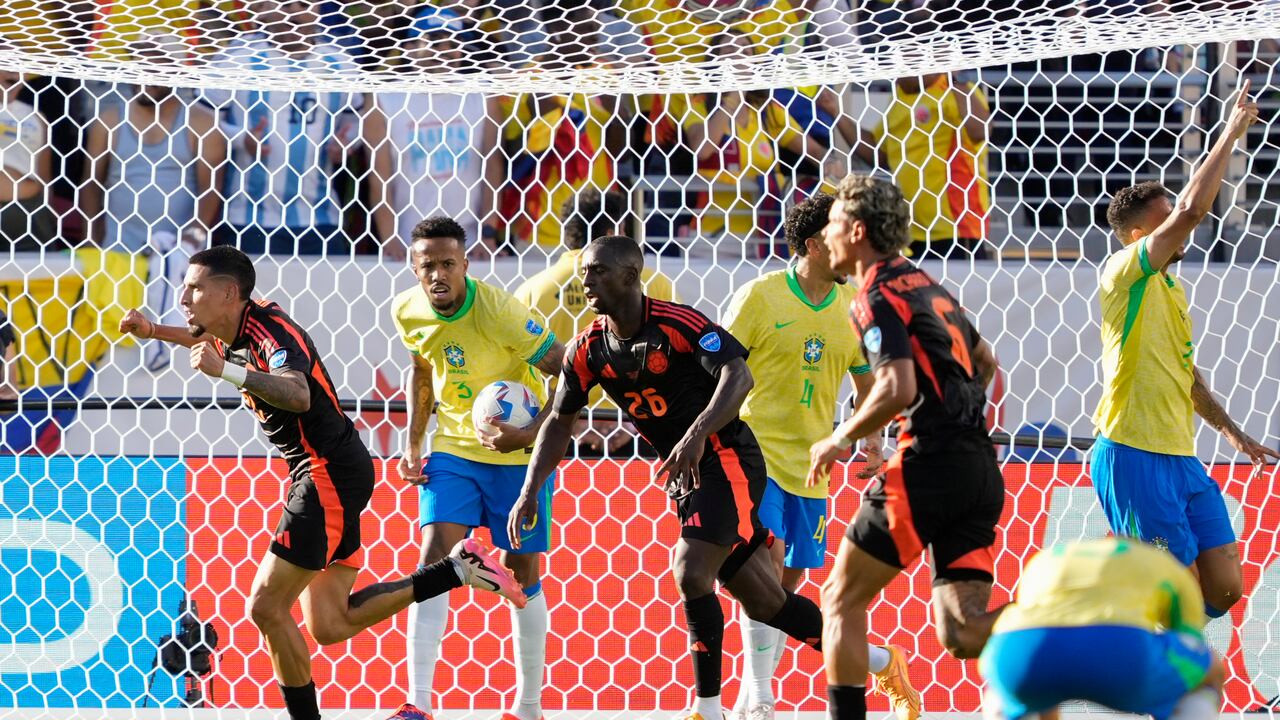 Colombia's Daniel Munoz, left, celebrates after scoring his side's first goal against Brazil during a Copa America Group D soccer match in Santa Clara, Calif., Tuesday, July 2, 2024. (AP Photo/Tony Avelar)