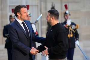 French President Emmanuel Macron, left, welcomes Ukrainian President Volodymyr Zelenskyy at the Elysee palace in Paris, Sunday, May 14, 2023. Ukrainian President Volodymyr Zelenskyy made a surprise visit to Paris for talks Sunday night with French President Emmanuel Macron, extending a multi-stop European tour that has elicited fresh pledges of military support as his country gears up for a counteroffensive against Russian occupation forces. (AP Photo/Michel Euler)