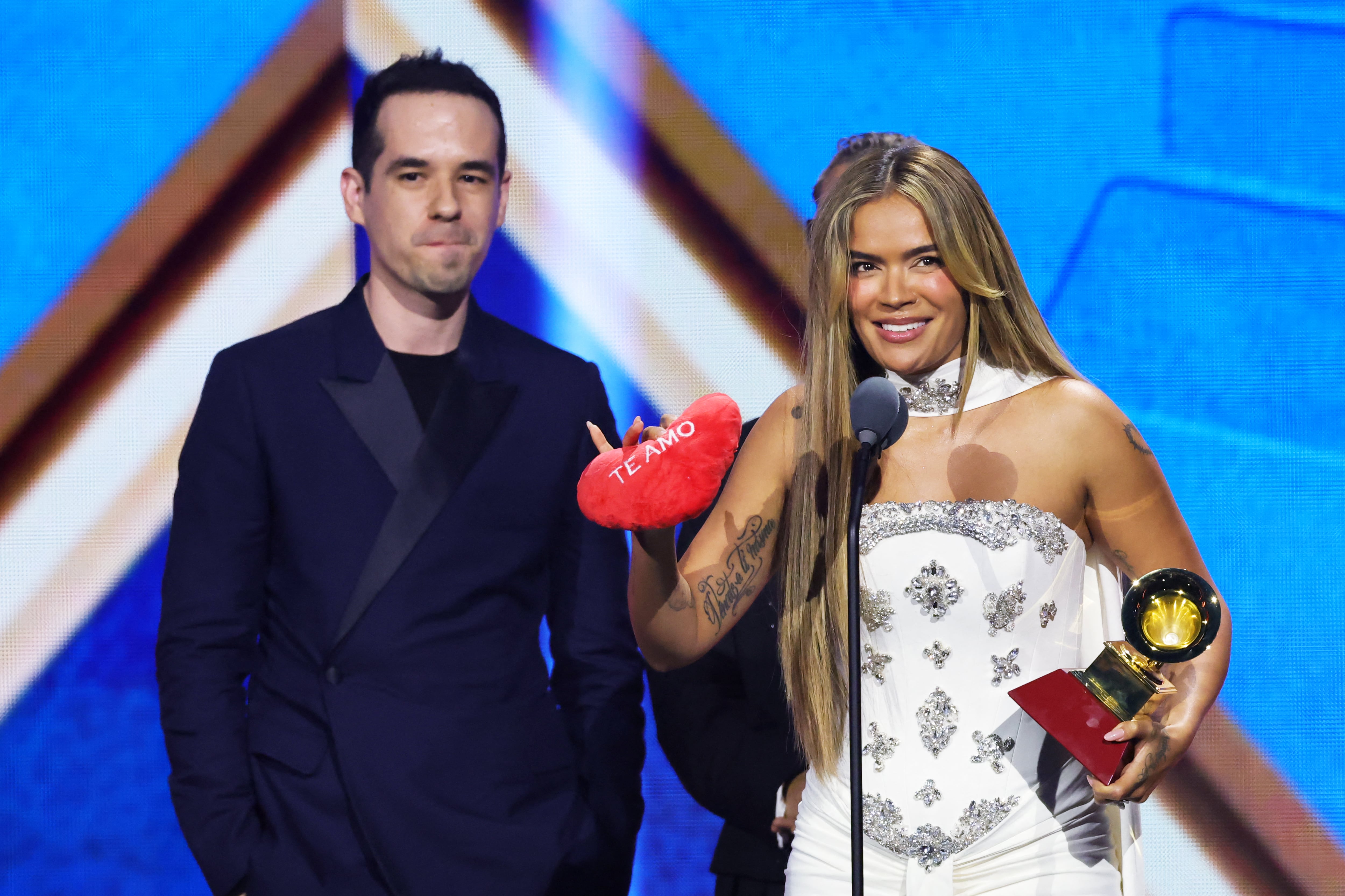 LAS VEGAS, NEVADA - NOVEMBER 13: (L-R) Edgar Barrera and Karol G accepts the Song Of The Year award for "Si Antes Te Hubiera Conocido" onstage during the 26th Annual Latin Grammy Awards at the MGM Grand Garden Arena on November 13, 2025 in Las Vegas, Nevada.   Kevin Winter/Getty Images for The Latin Recording Academy/AFP (Photo by KEVIN WINTER / GETTY IMAGES NORTH AMERICA / Getty Images via AFP)