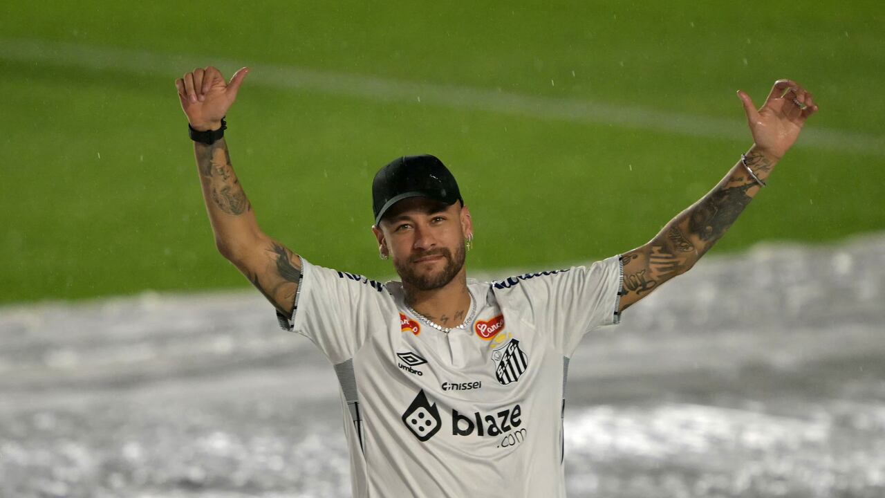 Brazilian football star Neymar waves to fans during his presentation as a new player of the Santos football team at the Urbano Caldeira Stadium in Santos, Sao Paulo state, Brazil on January 31, 2025. Star Neymar signed on Friday a �six-month� contract with Santos of Brazil, the club that formed him and to which he returns after his disappointing spell in Arabian soccer, according to the vice president of the Sao Paulo state team. (Photo by NELSON ALMEIDA / AFP)