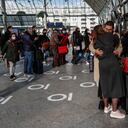 A couple kissing goodbye as passengers board a train at the Gare de Lyon train station in Paris, Friday, March 19, 2021. France's has ordered yesterday a partial lockdown for Paris and several other regions that takes effect on Friday night. (AP Photo/Michel Euler)
