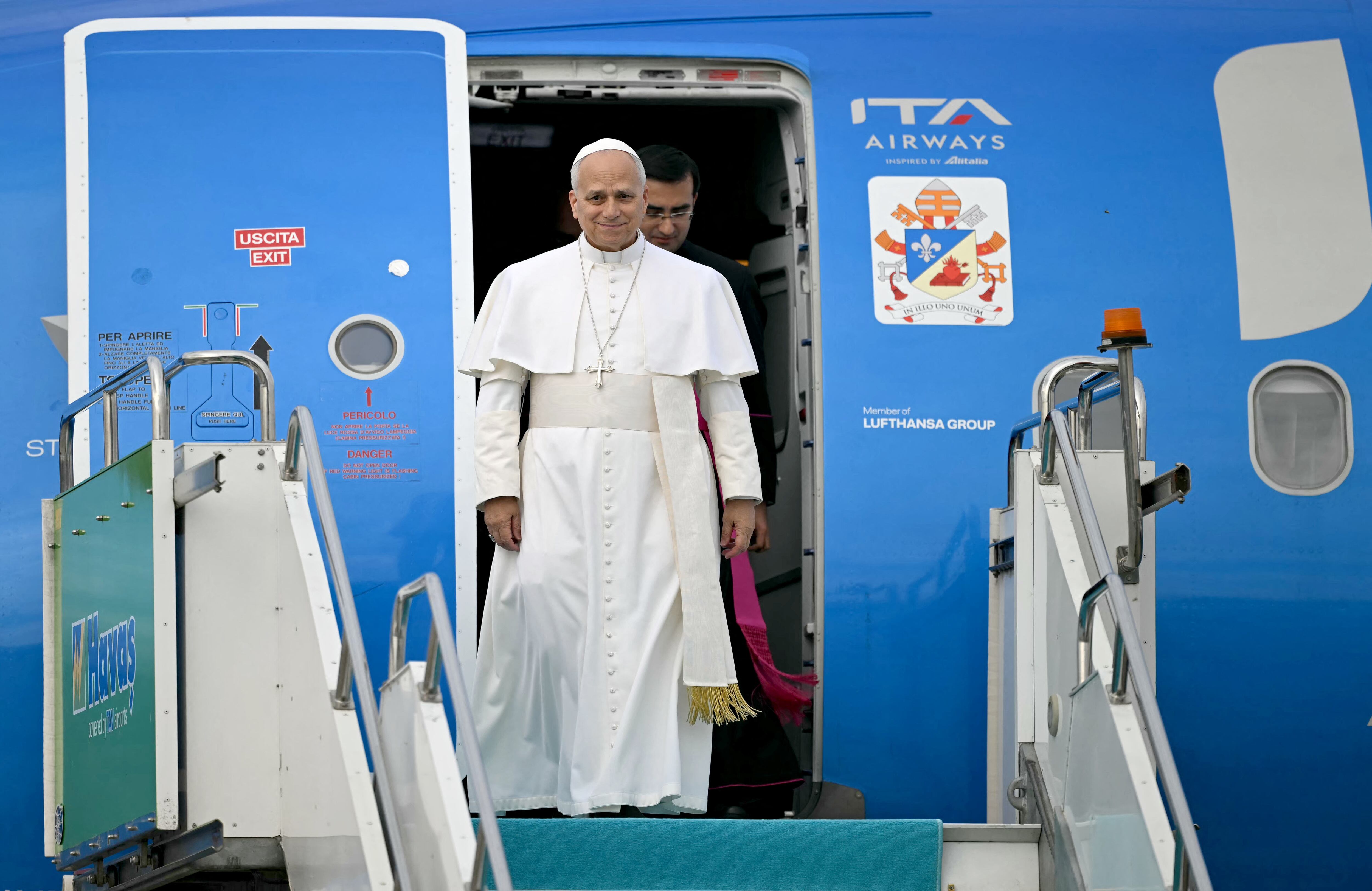 Pope Leo XIV disembarks from his plane after his arrival at Esenboga International Airport  in Ankara on November 27, 2025. Pope Leo XIV arrived in Turkey on the first overseas trip of his papacy, which will also take him to Lebanon. (Photo by Ozan KOSE / AFP)