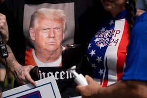 Supporters of former President Donald Trump and journalists gather in front of the Fulton County Jail in Atlanta on Thursday, Aug. 24, 2023. (AP Photo/Ben Gray)
