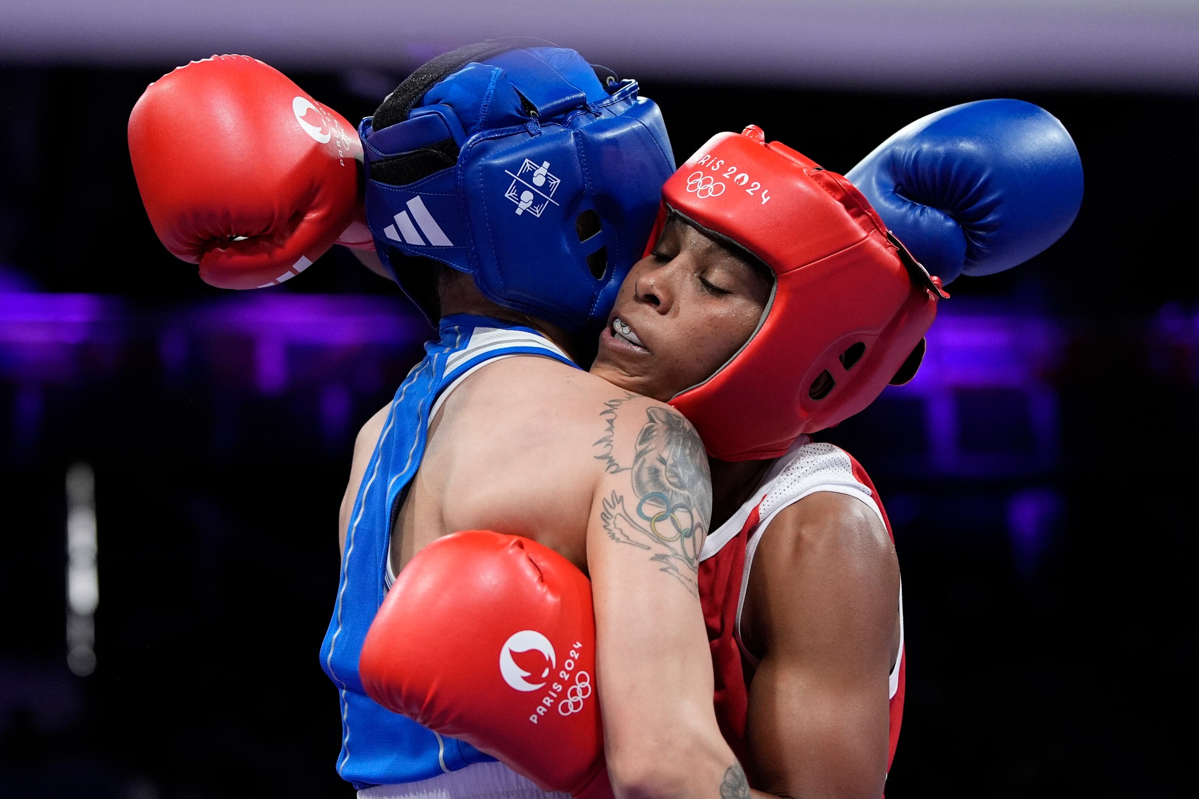 Colombia's Ingrit Valencia, right, fights Kazakhstan's Nazym Kyzaibay in their women's 50kg quarterfinal boxing match at the 2024 Summer Olympics, Saturday, Aug. 3, 2024, in Paris, France. (AP Photo/John Locher)