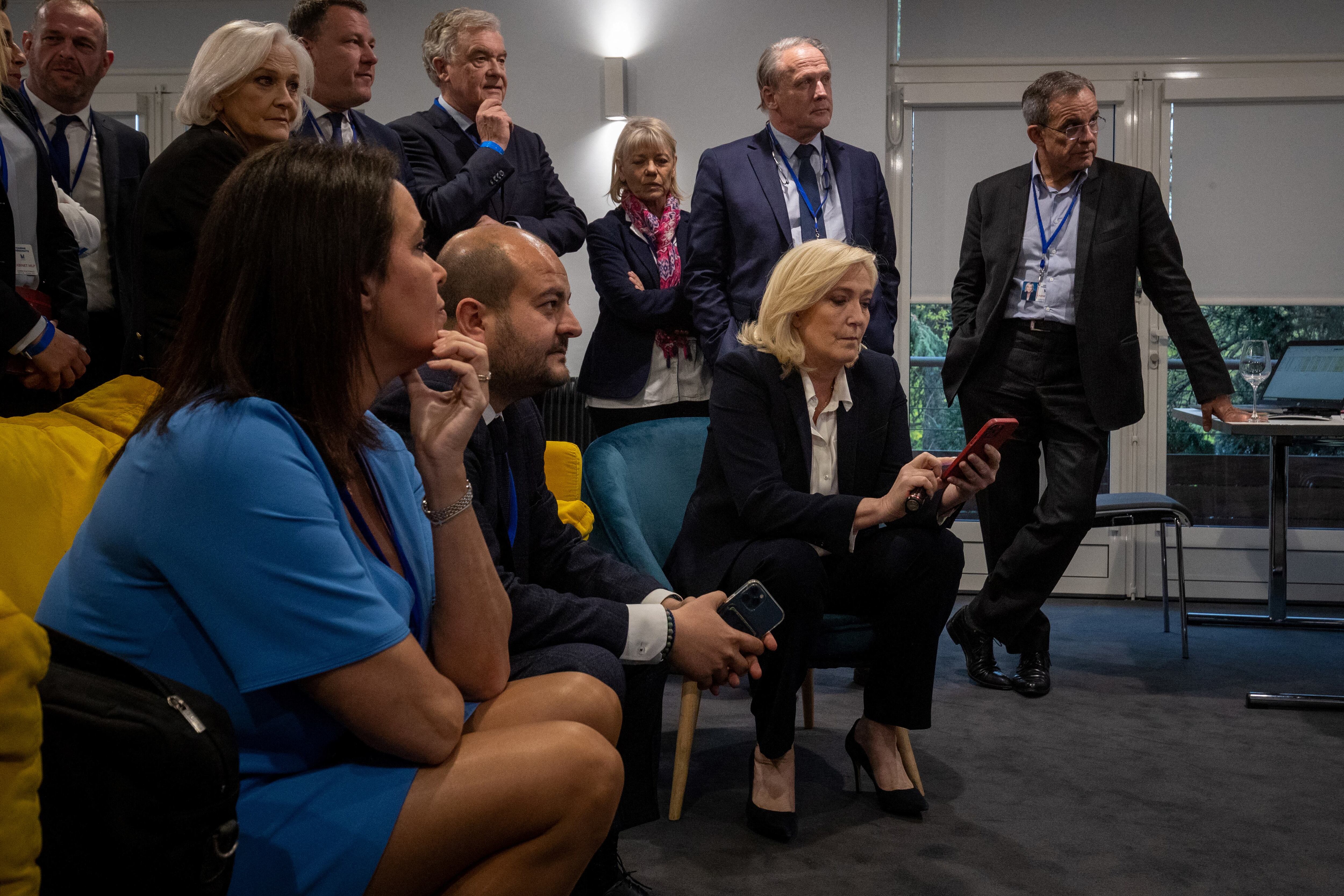 La candidata presidencial del partido de extrema derecha francés Rassemblement National (RN), Marine Le Pen (C), reacciona después de los primeros resultados de la primera ronda de las elecciones presidenciales en París, el 10 de abril de 2022. (Foto de JOEL SAGET / AFP)